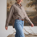 graced On Duty Gingham Button Up Top in brown worn with blue jeans and a brown leather belt