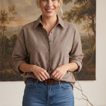 graced On Duty Gingham Button Up Top in brown micro-gingham worn by a smiling woman with blue jeans