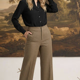 graced houndstooth knit straight pants in brown worn by a blonde model with a black button-down shirt