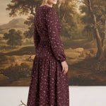 graced Audrey floral midi dress in deep burgundy with long sleeves and v-neckline worn by a blonde model