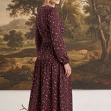 graced Audrey floral midi dress in deep burgundy with long sleeves and v-neckline worn by a blonde model