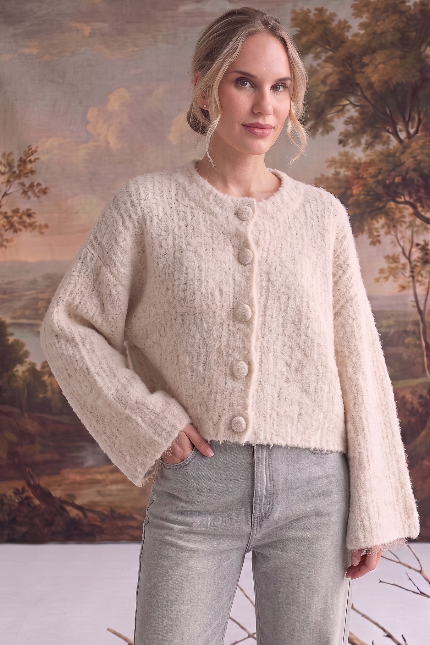 graced The Callie fuzzy knit cardigan in cream with a round neckline and button front, worn by a model.