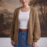 graced Chloe chunky knit olive cardigan worn by a model over a white top and denim skirt