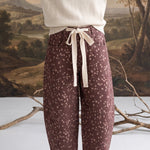 graced chocolate-brown barrel pants with a spotted Bambi print, featuring a contrasting cream bow-tie waist.