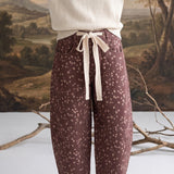 graced chocolate-brown barrel pants with a spotted Bambi print, featuring a contrasting cream bow-tie waist.