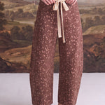 graced chocolate-brown barrel pants with a Bambi-inspired spotted print and a contrasting cream bow-tie waist