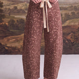 graced chocolate-brown barrel pants with a Bambi-inspired spotted print and a contrasting cream bow-tie waist