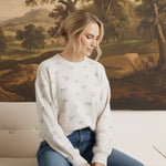 graced Courtney Horse Textured Top in cream with a subtle horse motif, worn by a model with blue jeans
