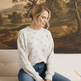 graced Courtney Horse Textured Top in cream with a subtle horse motif, worn by a model with blue jeans