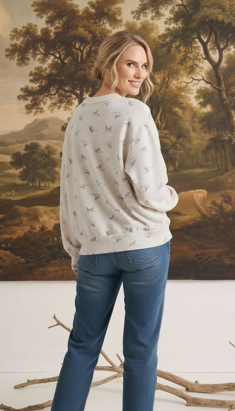 graced The Courtney Horse Textured Top in cream with grey horse motifs, worn by a blonde model from the back view.