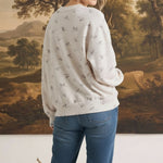 graced The Courtney Horse Textured Top in cream with grey horse motifs, worn by a blonde model from the back view.