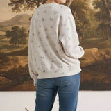 graced The Courtney Horse Textured Top in cream with grey horse motifs, worn by a blonde model from the back view.
