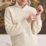 graced cream textured weave sweater with a relaxed fit and ribbed crew neck worn over a white collared shirt