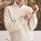 graced cream textured weave sweater with a relaxed fit and ribbed crew neck worn over a white collared shirt