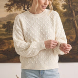 graced two tone textured weave sweater in cream with a relaxed fit worn by a woman with blonde hair