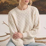 graced cream two-tone textured weave sweater with a crew neck and relaxed fit worn by a woman with light hair