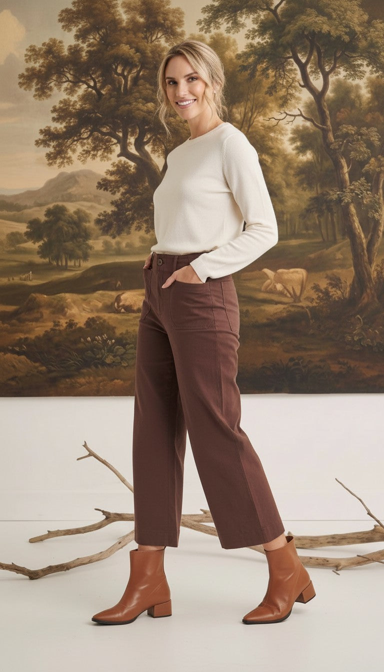 Model wearing graced The Darcy wide-leg cocoa pants with pocket details, paired with a cream sweater and brown boots.