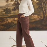 Model wearing graced The Darcy wide-leg cocoa pants with pocket details, paired with a cream sweater and brown boots.