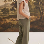 graced The Darcy wide-leg pants in dark olive with pocket detail, worn by a blonde model in a beige sleeveless top.