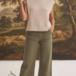graced The Darcy wide-leg pants in dark olive with front pocket detail, styled with a beige knit top and ankle boots.