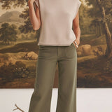 graced The Darcy wide-leg pants in dark olive with front pocket detail, styled with a beige knit top and ankle boots.