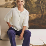 graced Darcy navy wide-leg pants with pocket detail worn by a model in a white cardigan and cream ankle boots