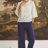 Model wearing graced The Darcy navy wide-leg pants with pocket detail and a cream button-down knit cardigan