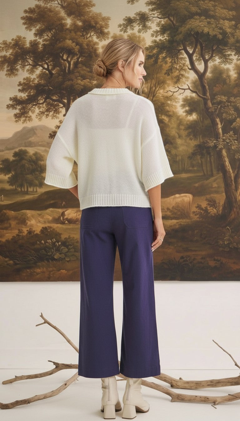 graced The Darcy navy wide-leg pants with back pocket detail worn with a white sweater and cream boots