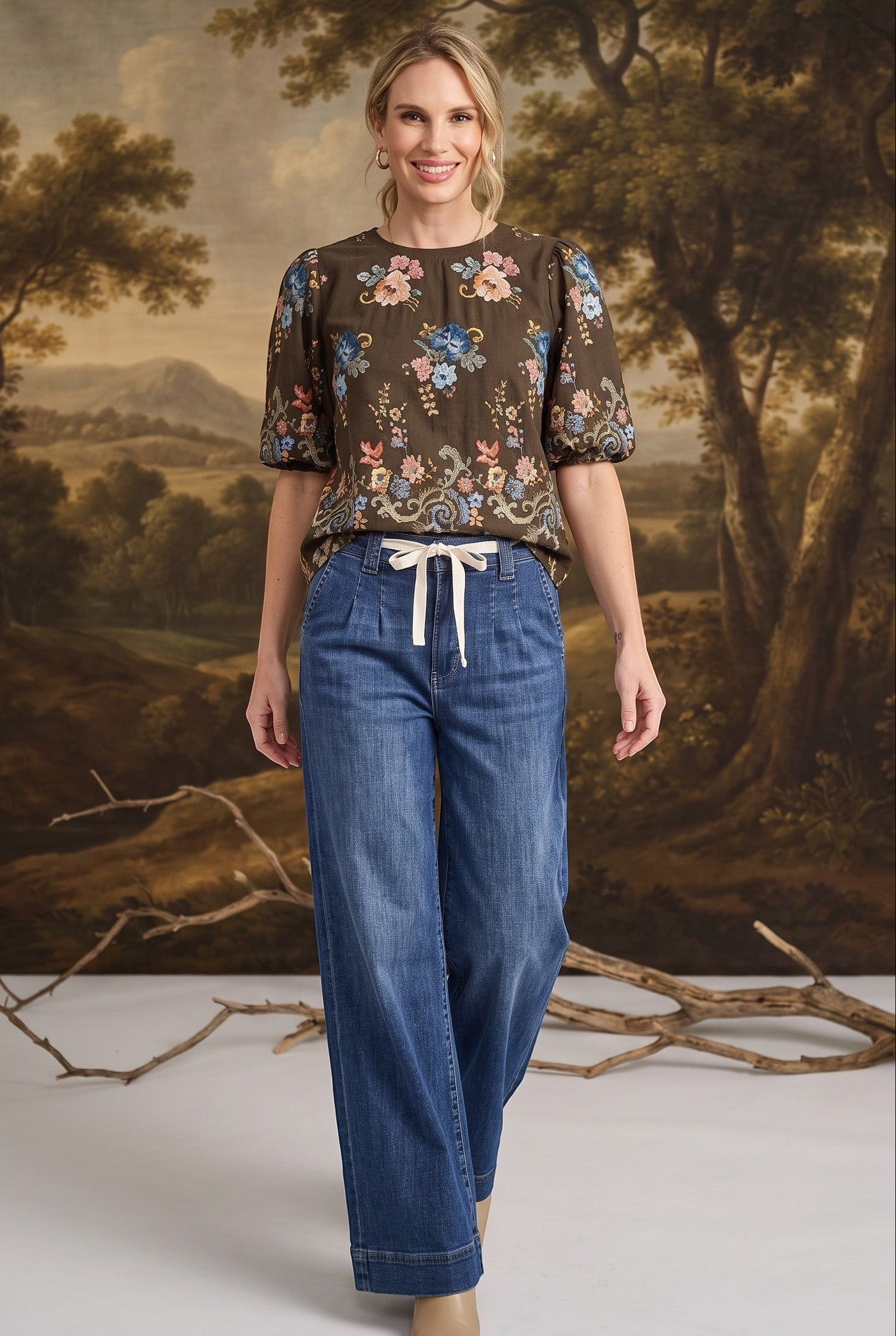 graced dark denim tie-front pants with a relaxed fit worn by a model in a floral blouse