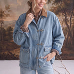graced Julie denim jacket with brown corduroy collar and metal latch hook closures worn by a smiling model