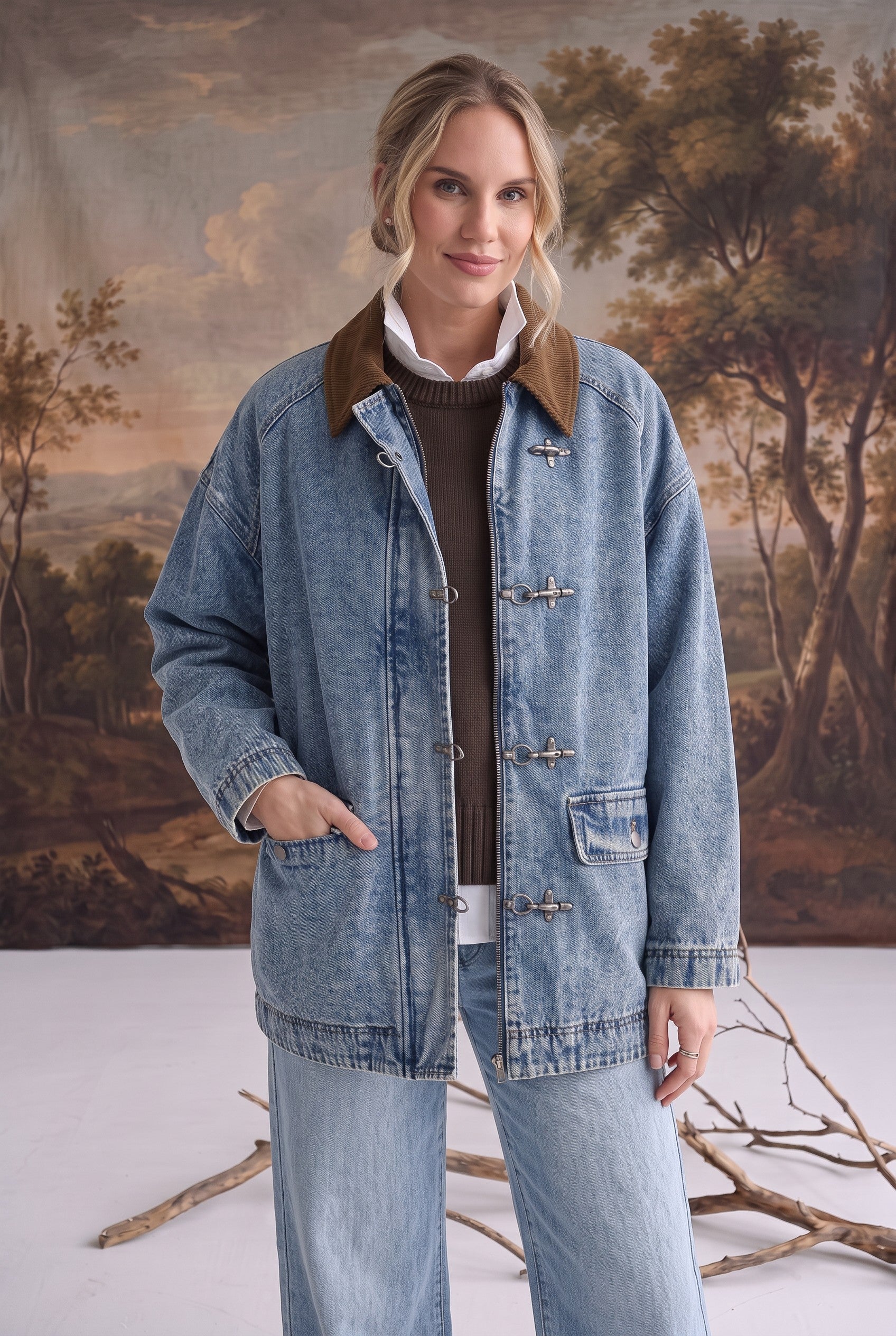 graced Julie denim jacket with brown corduroy collar and latch hook closures worn by a model in a studio setting