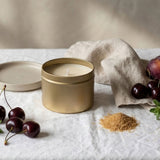 Gold tin candle by graced featuring a sleek label, designed for home fragrance with natural soy wax for a warm, inviting ambiance.