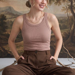 Model wearing a taupe graced Ellie Bra Free Tank in a ribbed, stretchy fabric with a relaxed, sleeveless fit.