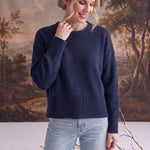 Model wearing a navy graced Eloise crew neck sweater with dropped shoulders and wide ribbed cuffs and hem.