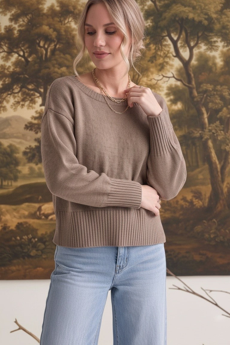 Model wearing a taupe graced Eloise crew neck sweater with drop shoulders and wide ribbed cuffs and hem.