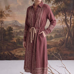graced midi dress in dusty rose with contrast embroidery, button front, and drawstring waist on a model