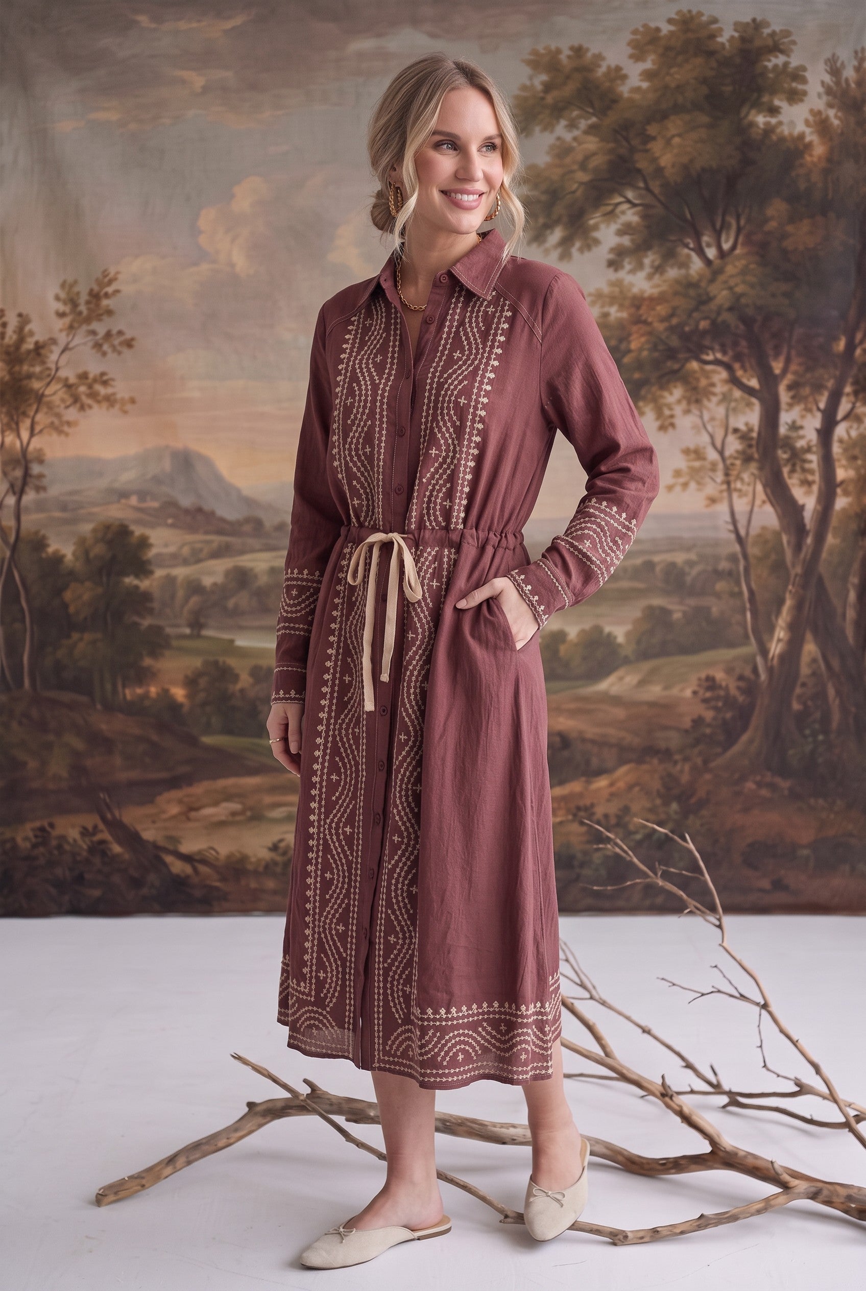 graced midi dress in dusty rose with contrast embroidery, button front, and drawstring waist on a model