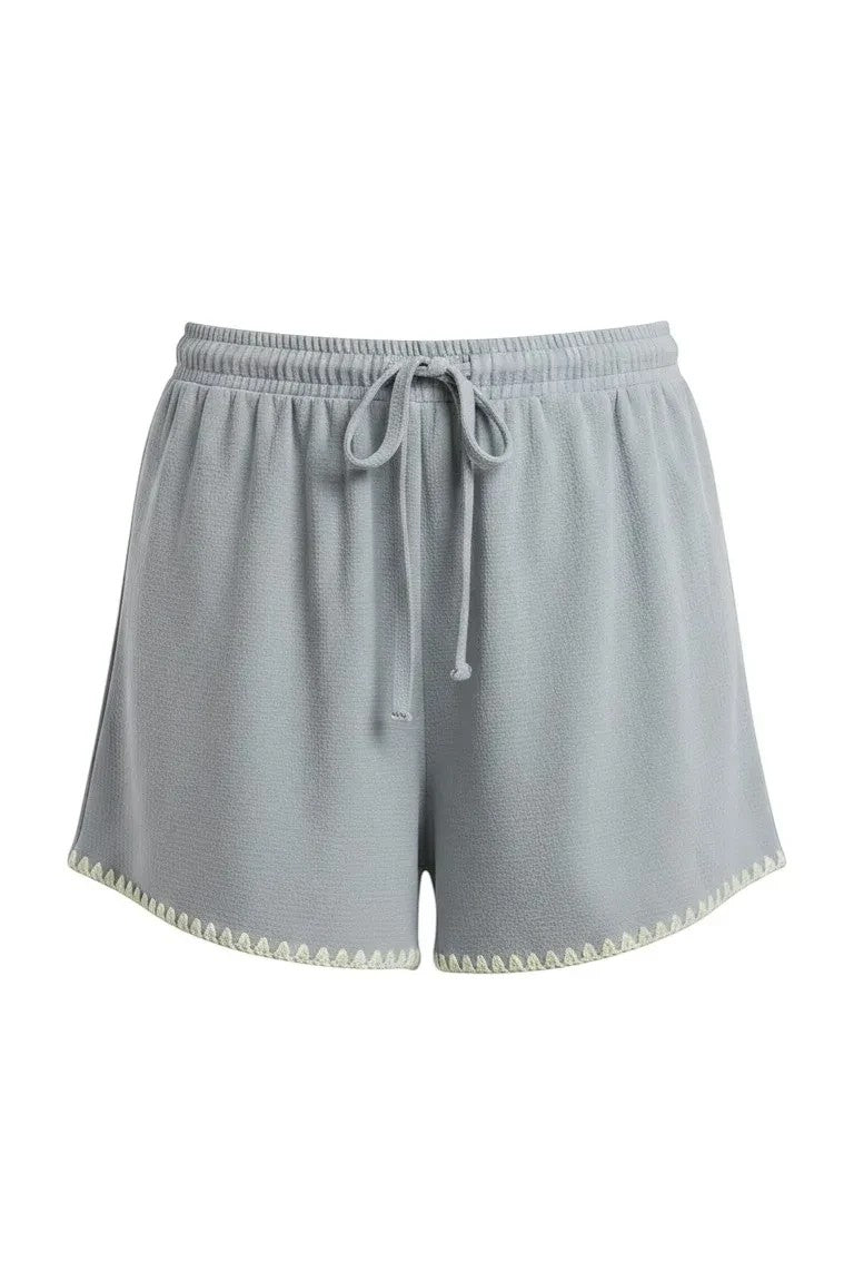 Allie Rose embroidered linen tie shorts featuring elegant embroidery, lightweight fabric, and a stylish relaxed fit for summer wear.