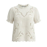 Off-white embroidered short sleeve blouse by Camellia featuring delicate floral embroidery and a relaxed fit.