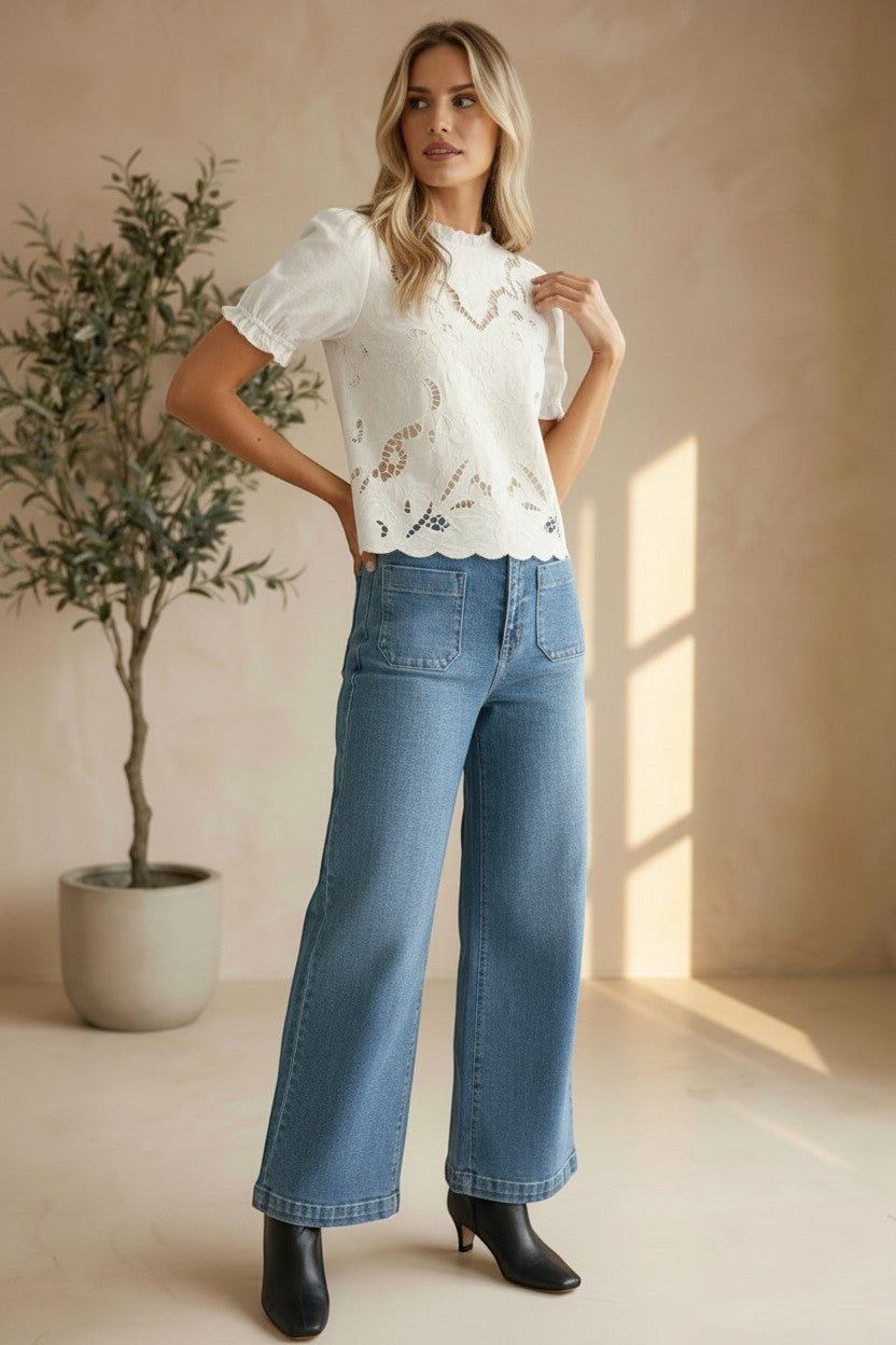 Off-white embroidered short sleeve blouse by Camellia, featuring delicate floral embroidery and lightweight fabric.