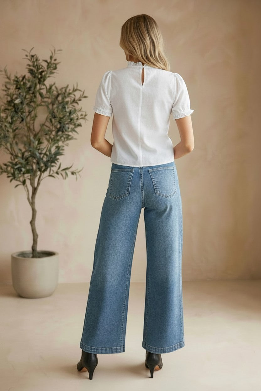 Off-white embroidered short sleeve blouse by Camellia, featuring intricate embroidery and lightweight fabric, perfect for casual or dressy wear.