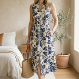 Doe and Rae V-neck smocked waist midi dress with floral pattern, featuring a front zipper and flowing silhouette.
