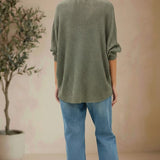 graced forest green dolman long sleeve knit sweater with a relaxed fit worn with blue jeans