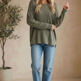 Model wearing a graced forest green dolman long sleeve knit sweater with a chest pocket and relaxed fit.