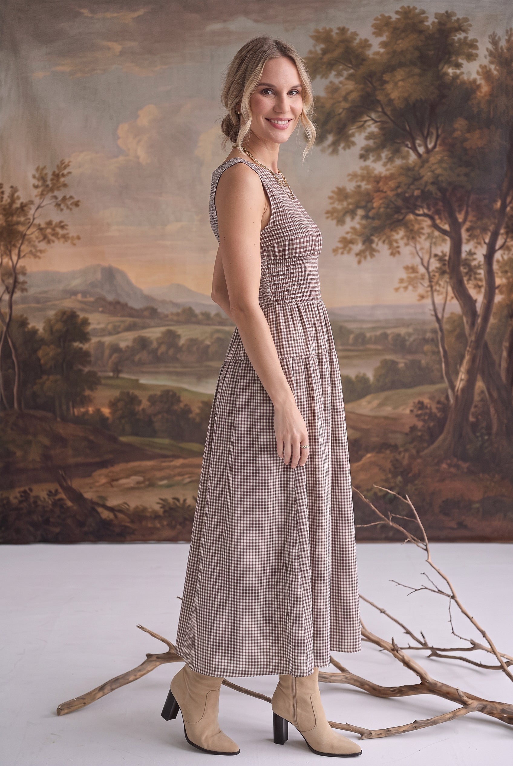 graced The Harper brown gingham midi dress with a smocked bodice worn by a model in a studio setting