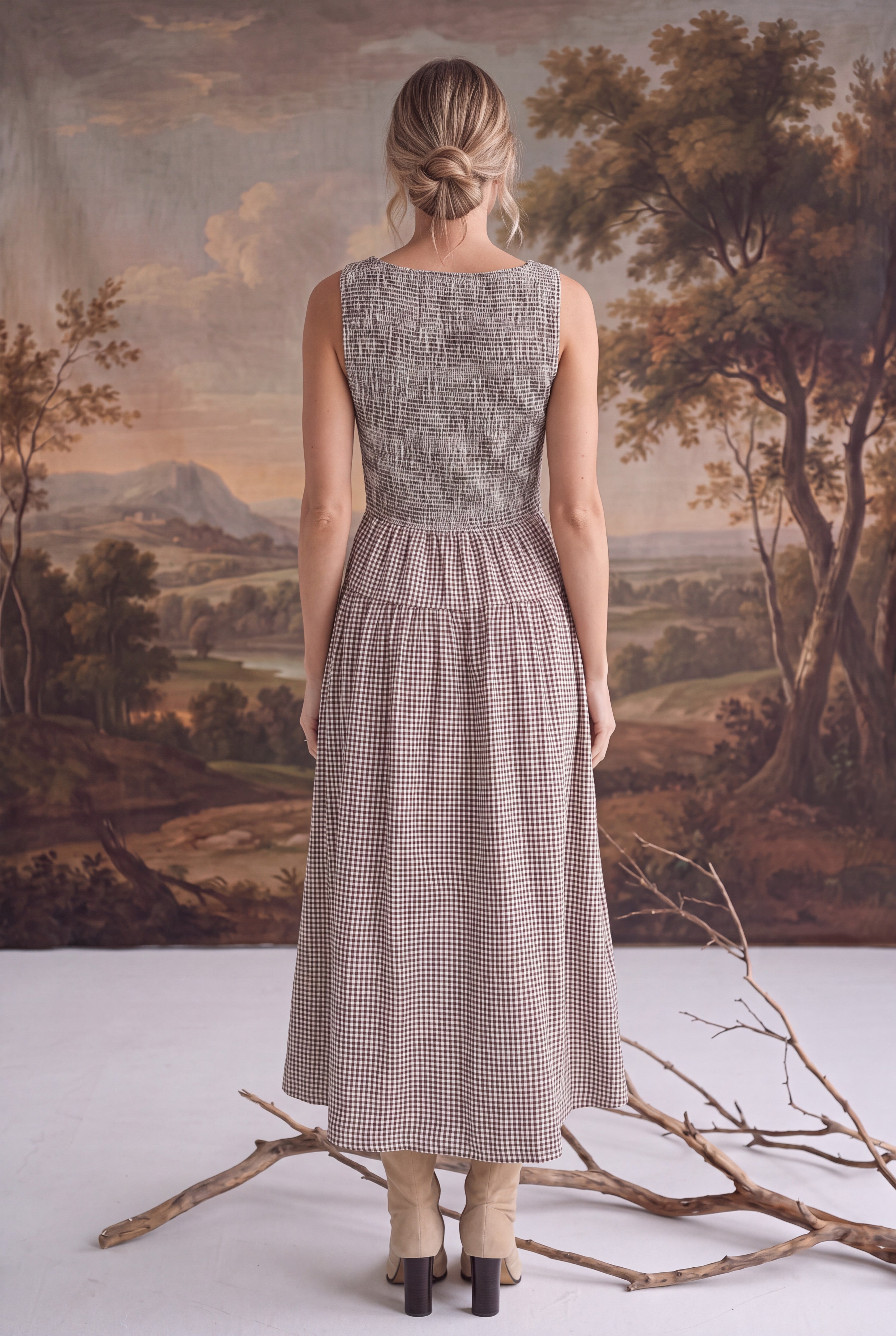 Back view of a graced Harper smocked gingham midi dress in brown and white, featuring a fitted bodice and midi length.