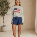graced blue denim high-waisted shorts with elastic waist and tie detail, 3" inseam, 90% cotton