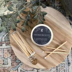 Graced Homebody mini candle in a cozy container, perfect for home fragrance and creating a warm, inviting atmosphere.