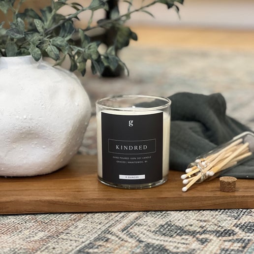 Graced Kindred 9oz candle for home fragrance, featuring a sleek design and warm glow perfect for cozy ambiance.