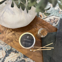 Small graced Kindred candle for home fragrance, featuring a minimalist design and warm, inviting appearance.